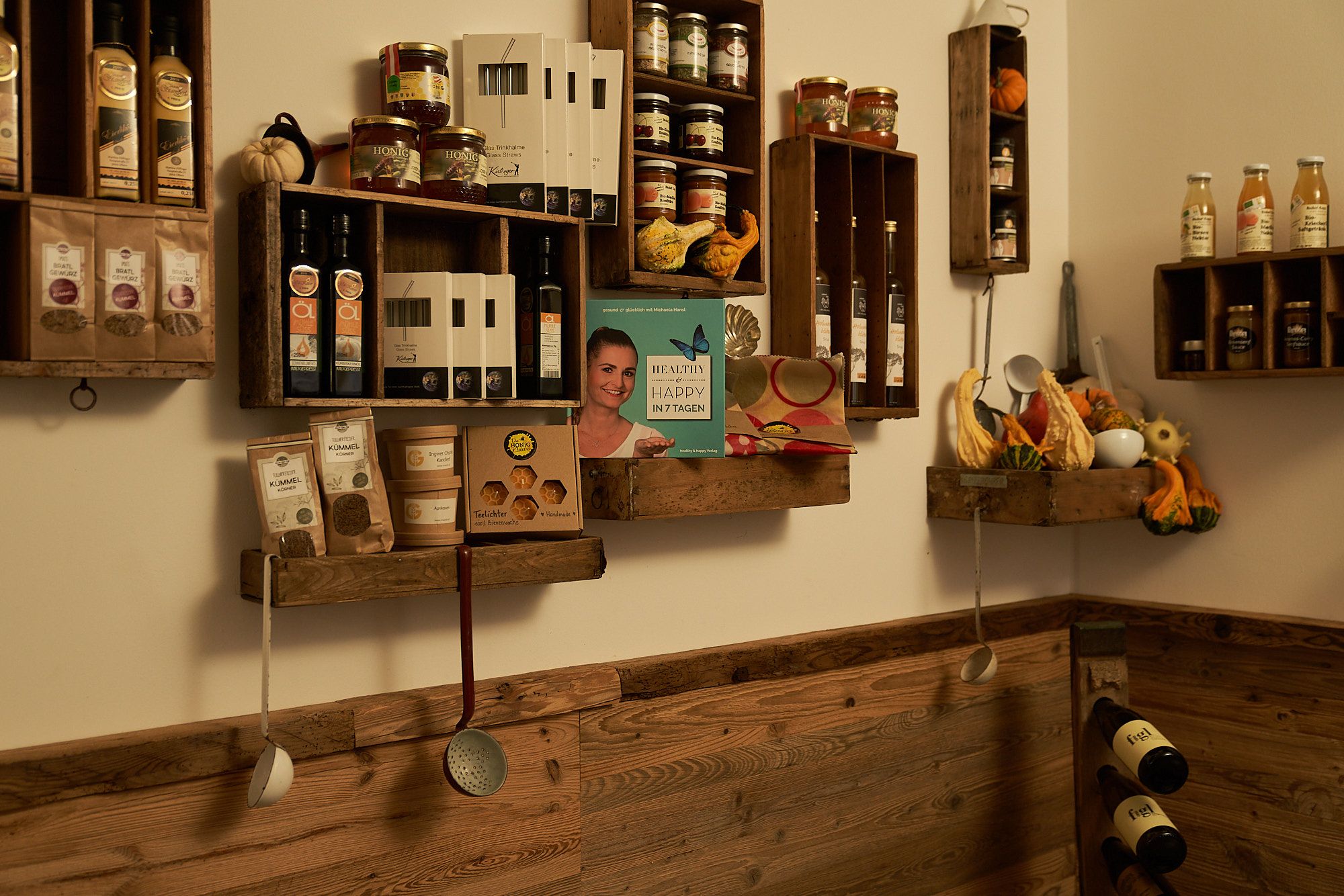 Shelves with food and cooking utensils on a wooden wall.