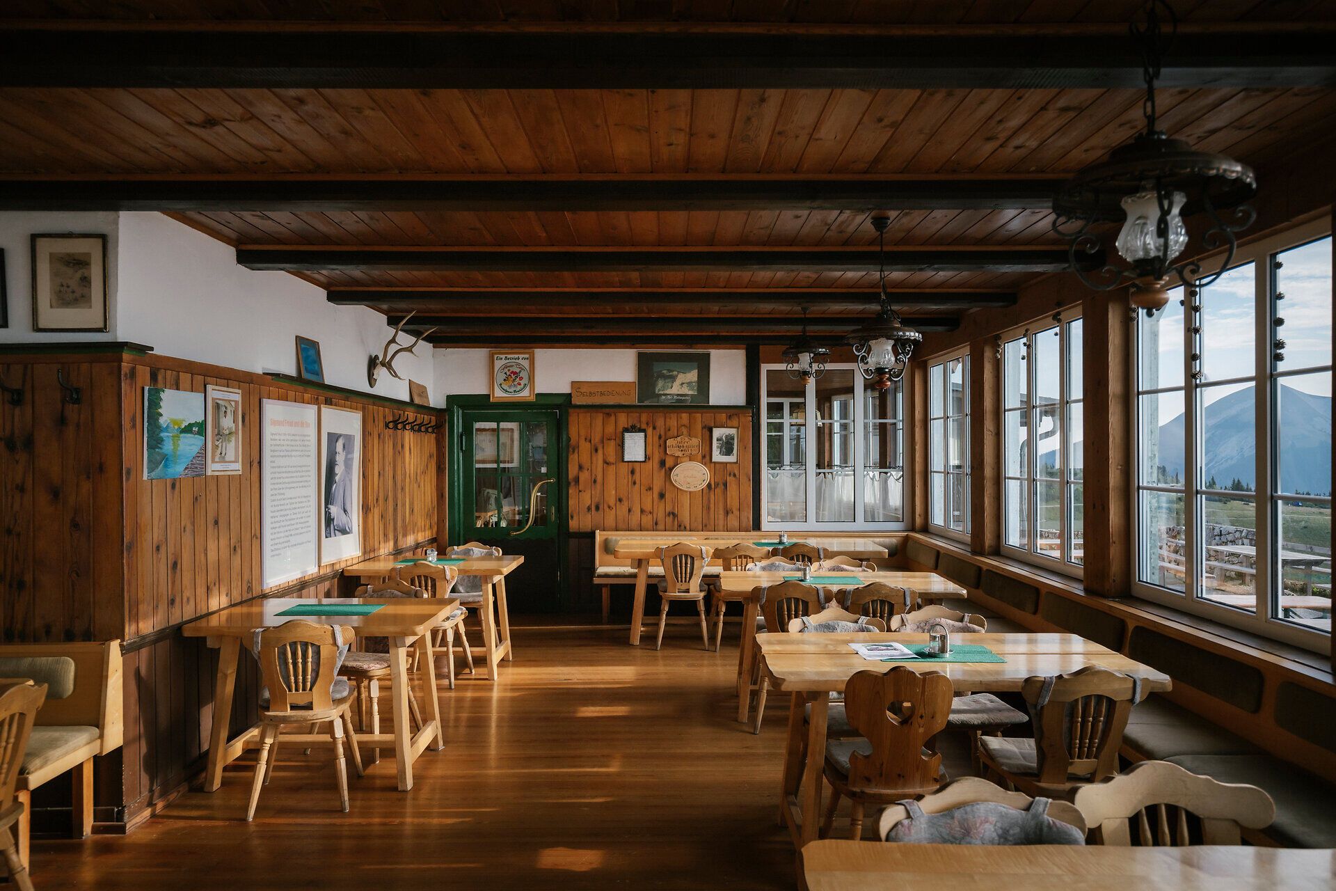 Wood-paneled dining room with large windows at the Ottohaus on the Rax