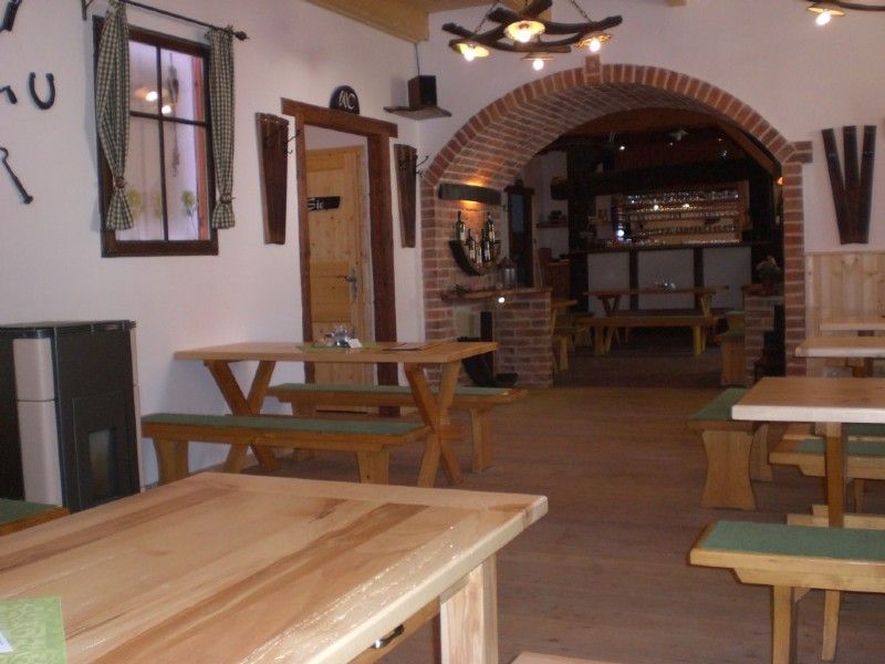 Interior view of a traditional wine tavern with wooden tables and benches.