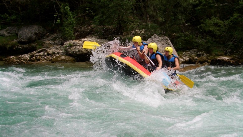 Group of people rafting on a wild river.