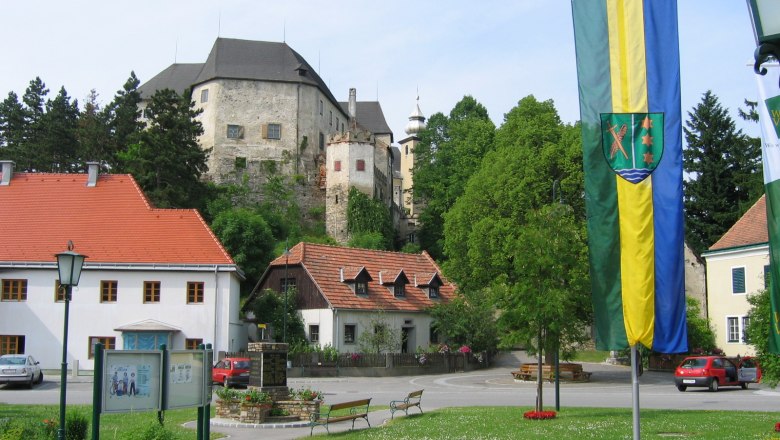 Main square in Albrechtsberg with castle in the background and flag in the foreground.