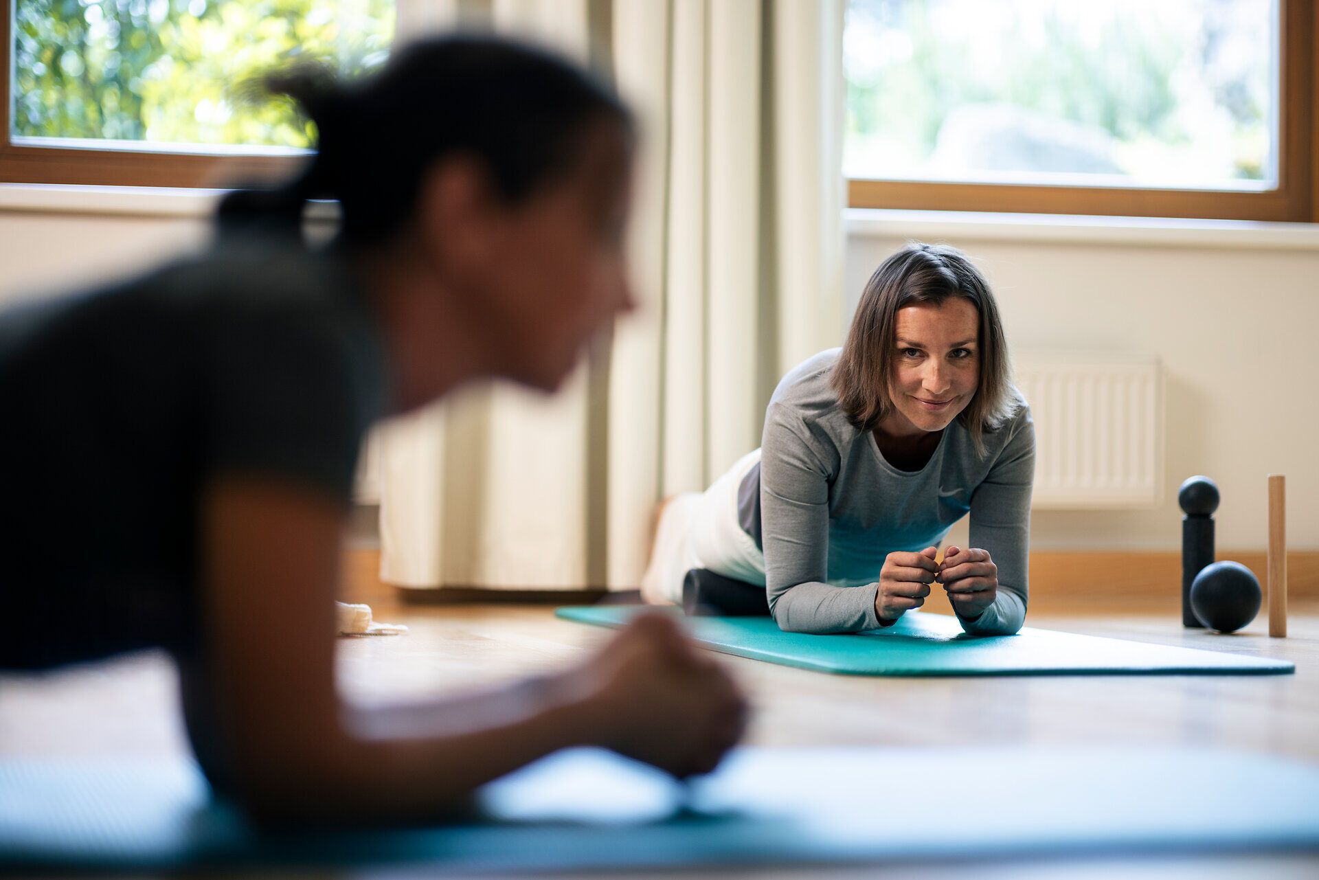 A woman is exercising on a mat at the Klosterberg Health Hotel in the Waldviertel region.