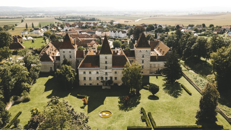 Aerial view of Walpersdorf Castle with surrounding landscape.