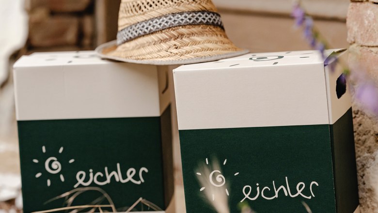 Two boxes with the inscription 'eichler' and a straw hat on them.