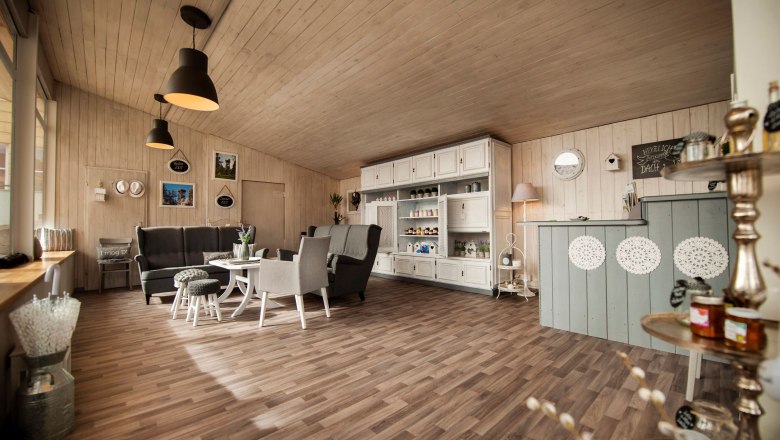 Interior view of a cozy regional store with wooden furniture and decorations.