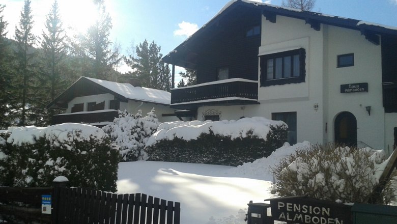 House Almboden, © Fam. Ullram Snow-covered house with 'Pension Almboden' sign in the foreground.