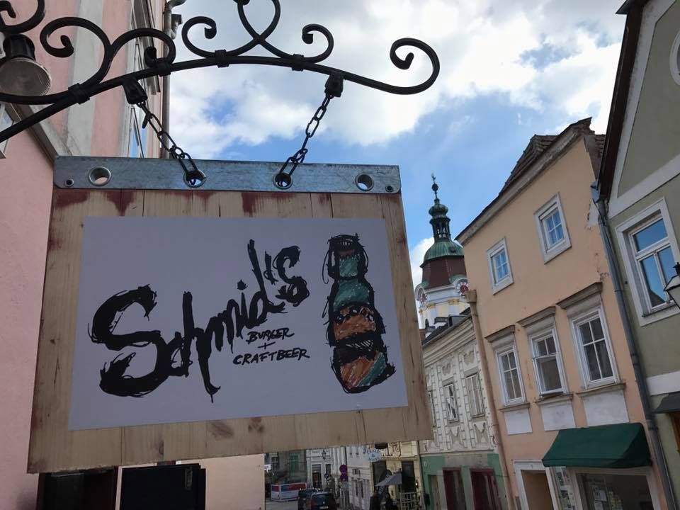 Sign for Schmid's Burger and Craftbeer on the wall of a house in an old town street.