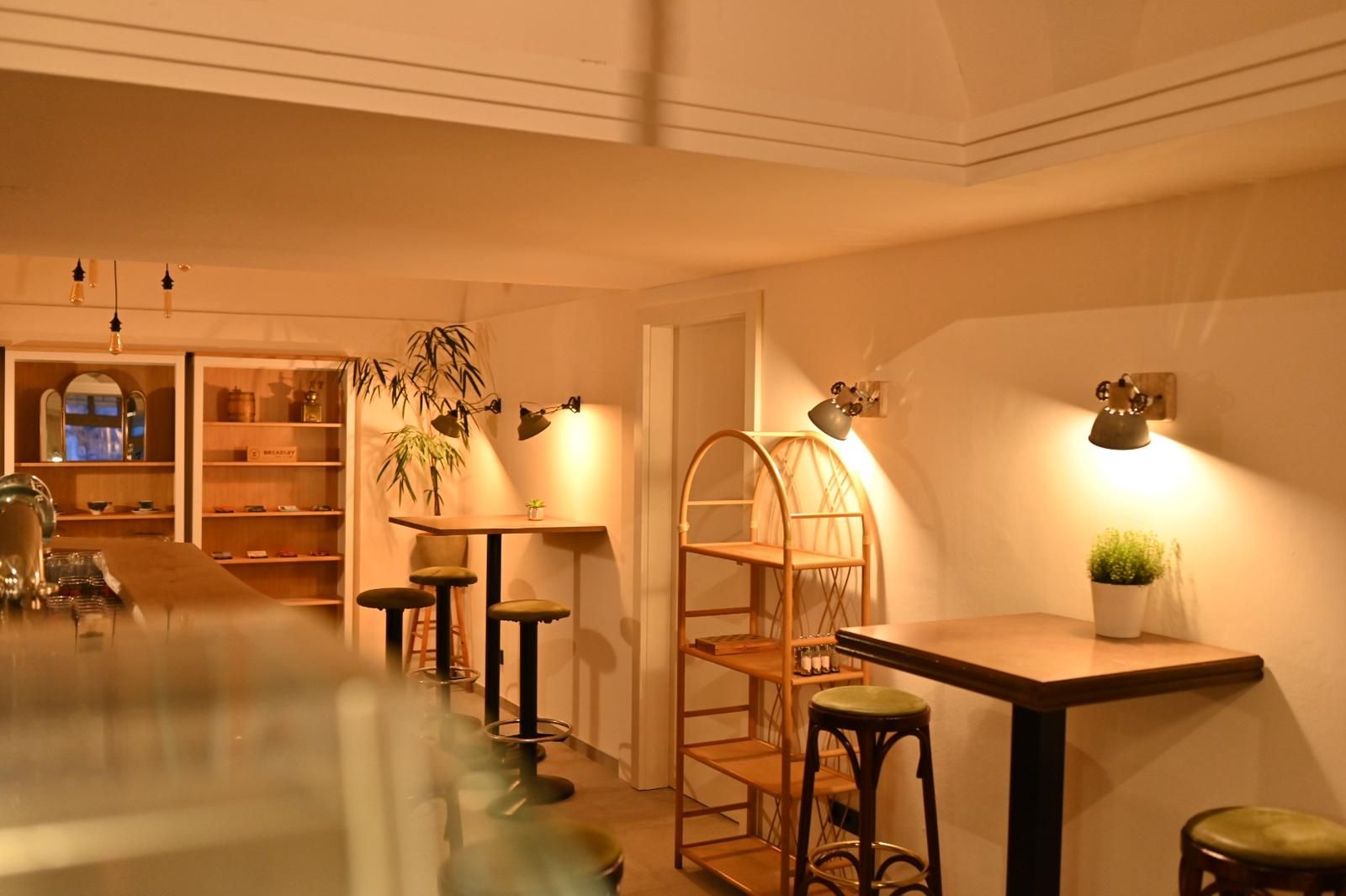 Interior view of a cozy café with wooden furniture and warm light.