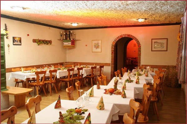 Cozy dining room with wooden furniture and laid tables.
