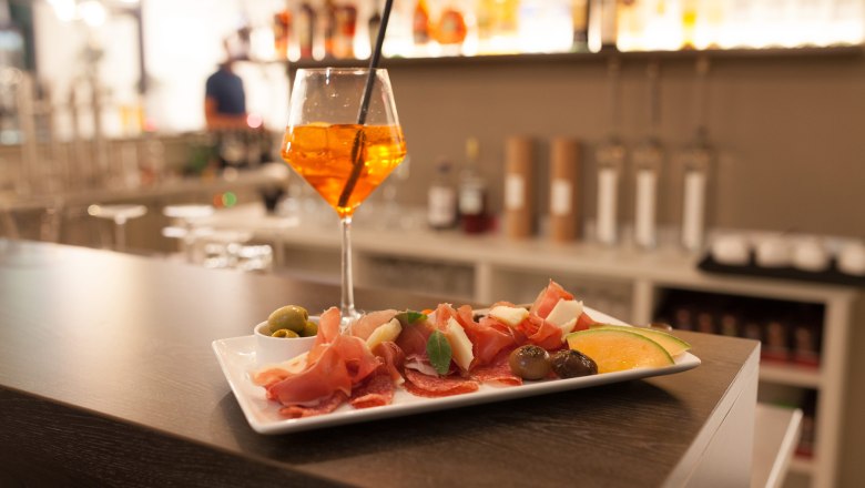 Small snack and drink in a wine glass at the hotel bar