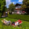 Two women relaxing in deckchairs in the garden of an inn.