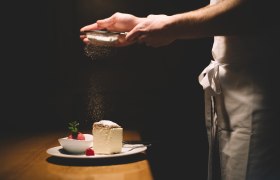 A plate with cream slice and raspberry sorbet, sprinkled with powdered sugar.