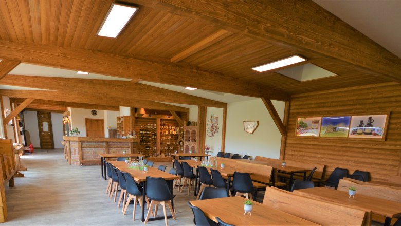 Interior view of a rustic room with wooden furniture and decorations.