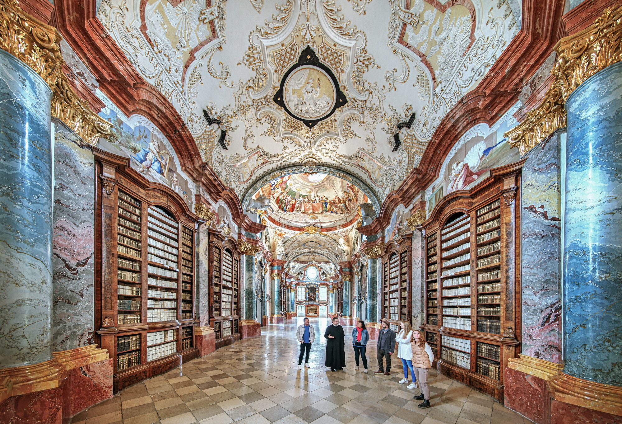 Magnificent baroque hall with ornate ceiling and bookshelves in Altenburg Abbey.