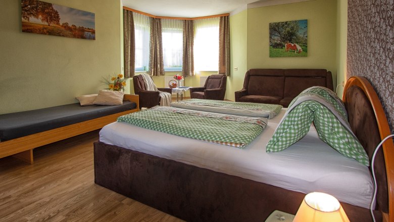 Room with double bed and sofa