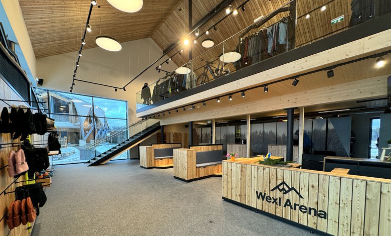 Interior view of the Wexl Base service center with wooden furniture and a staircase.