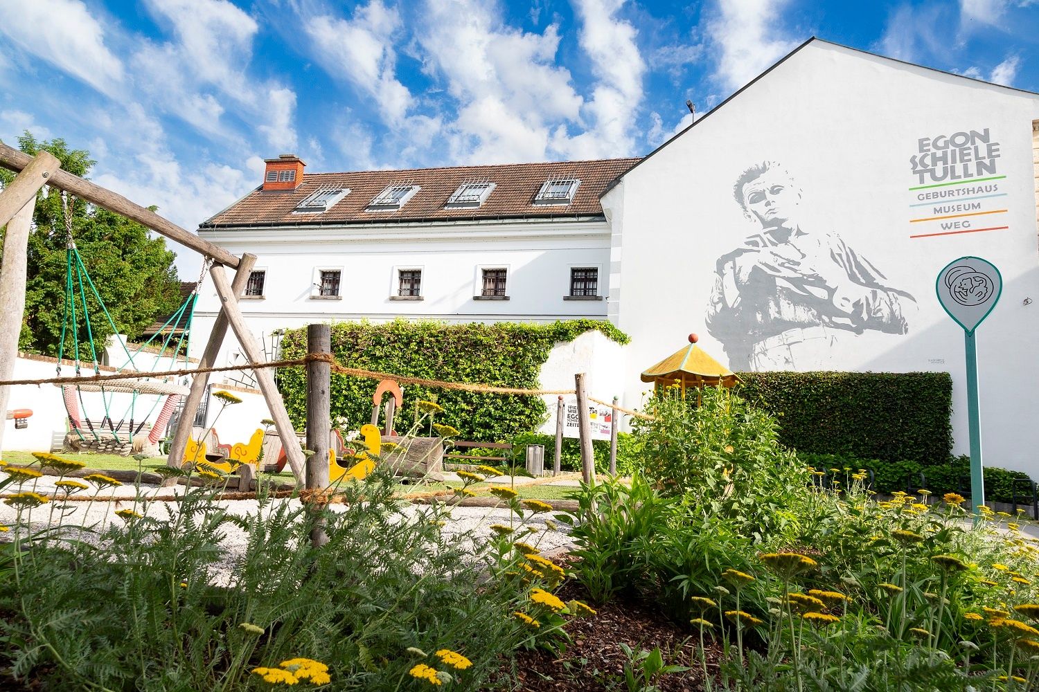Playground in front of the house where Egon Schiele was born in Tulln with a mural.