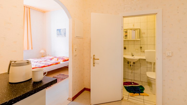 Interior view of a vacation apartment with a view of the bedroom and bathroom.