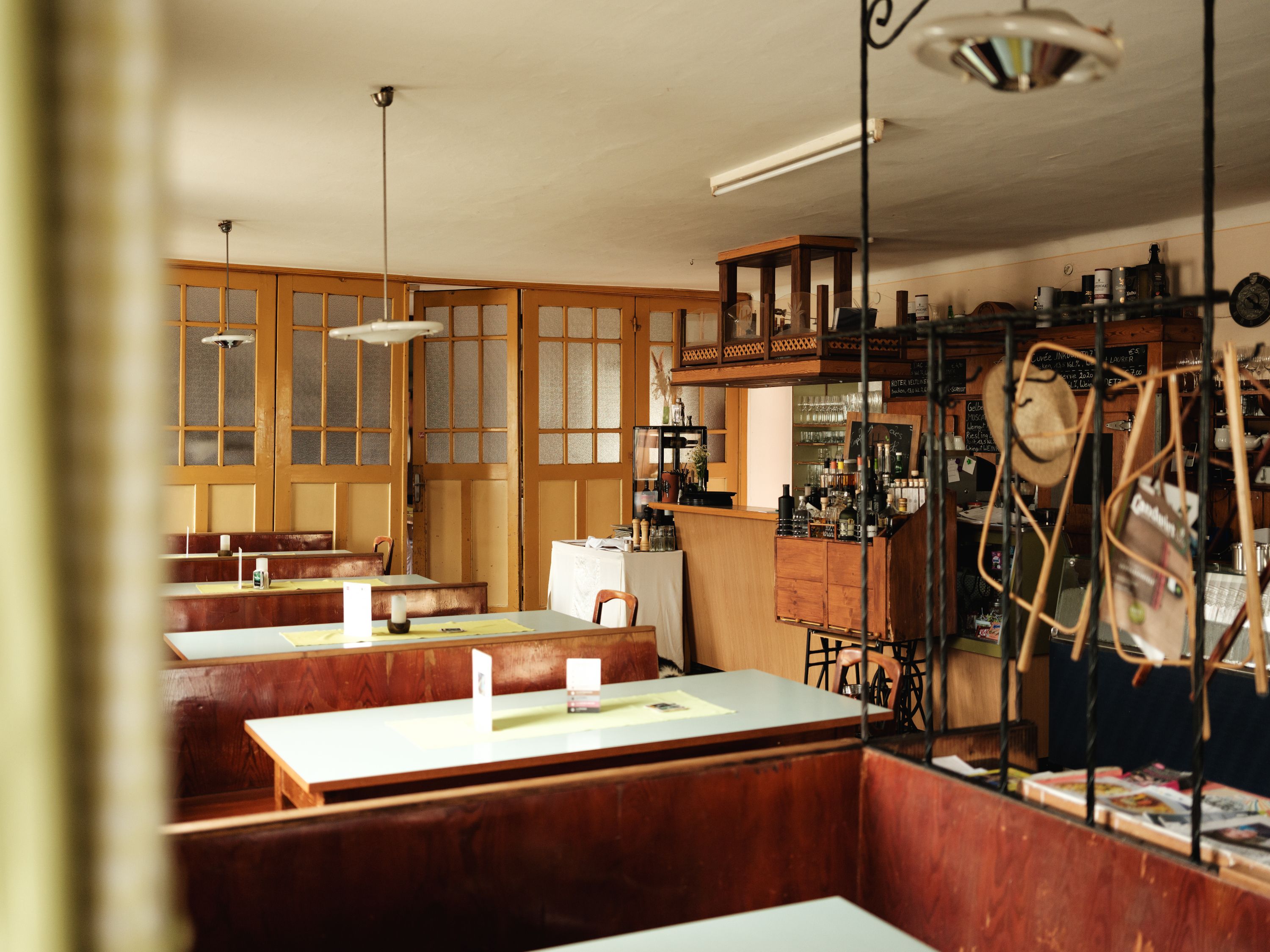 Interior view of a traditional inn with wooden tables and bar.