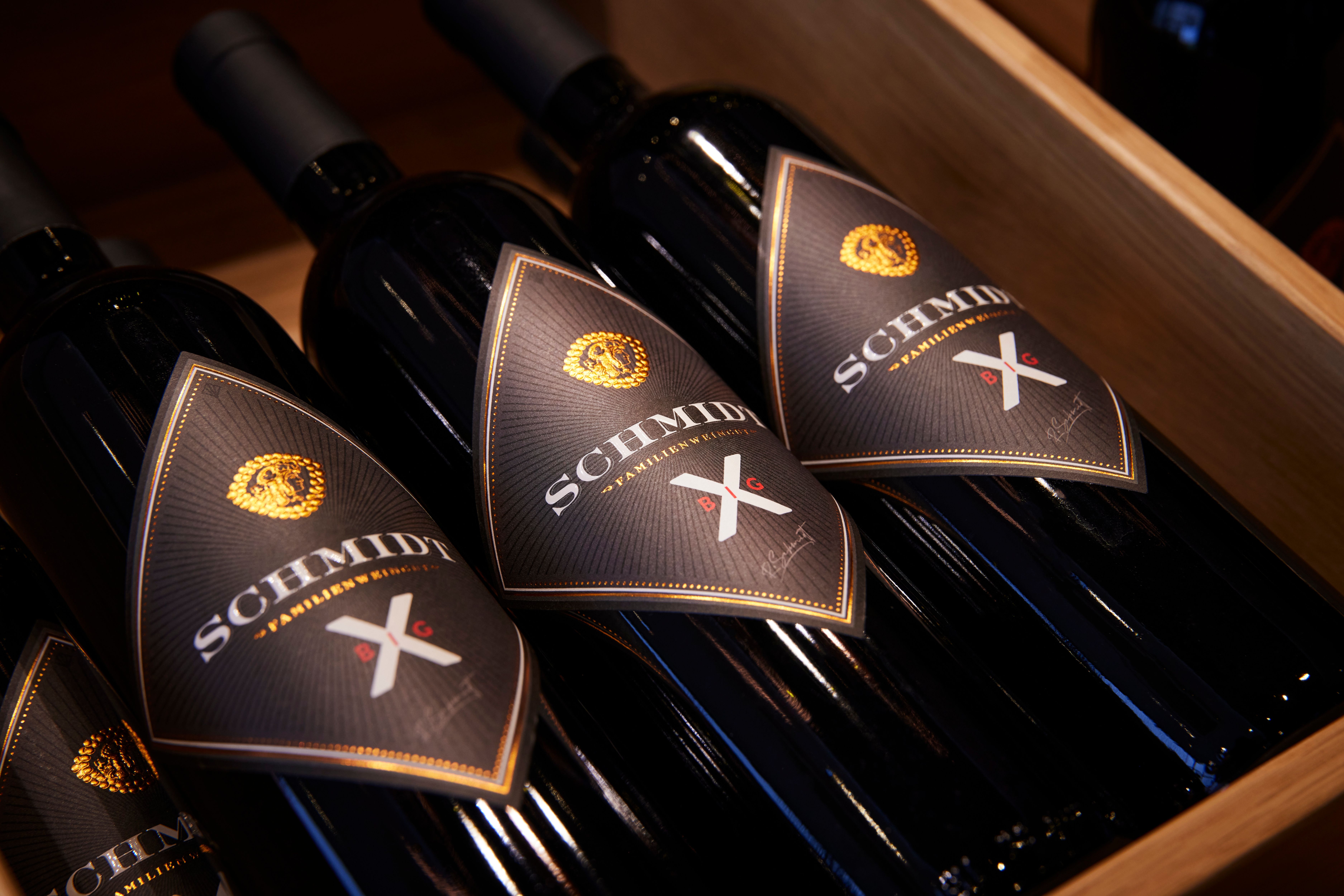 Three Schmidt brand wine bottles in a wooden box.