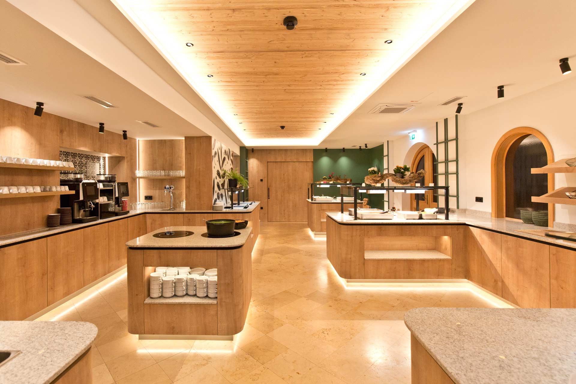 Modern buffet area with wood paneling and lighting.