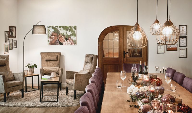 Cozy tasting room with table, chairs, armchairs and decoration.