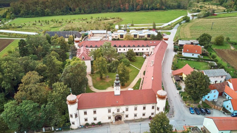 Aerial view of Schiltern Castle with surrounding landscape and buildings.