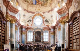 Concert in the baroque library of Altenburg Abbey with orchestra and choir.