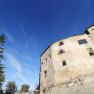 Plankenstein Castle against a blue sky with trees in the foreground.