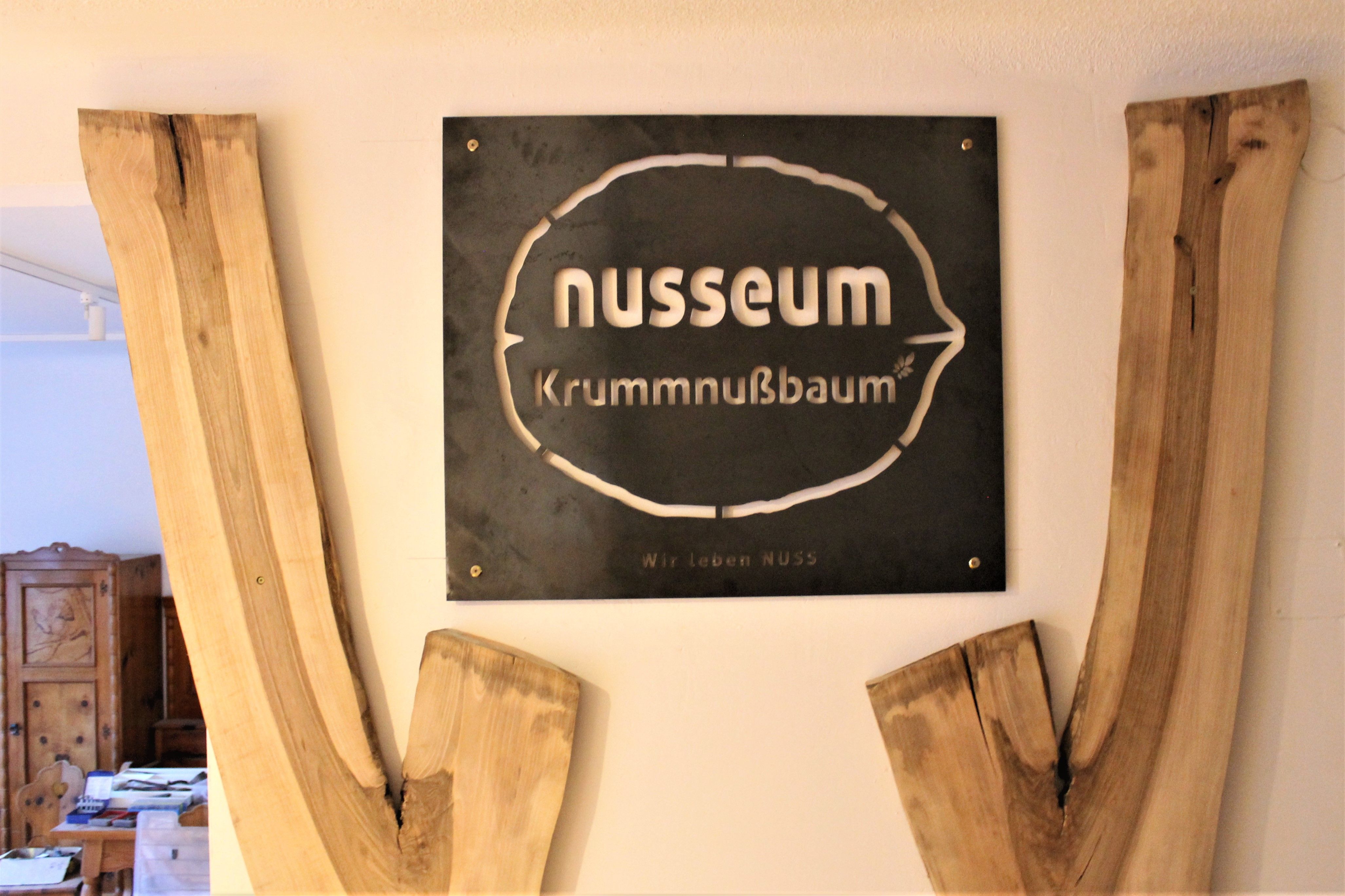 Sign of the Nusseum Krummnußbaum with wooden decoration.