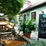 Cozy guest garden with wooden benches and table at Wirtshaus Bonka, Wienerwald.