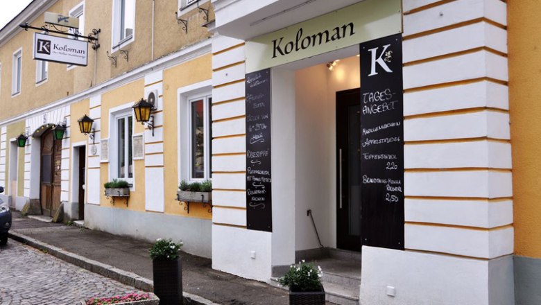 Entrance to Restaurant Koloman in Melk with daily specials on blackboards.