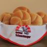 A basket of fresh bread rolls, covered with a napkin from the Helmut Schneeberger bakery.