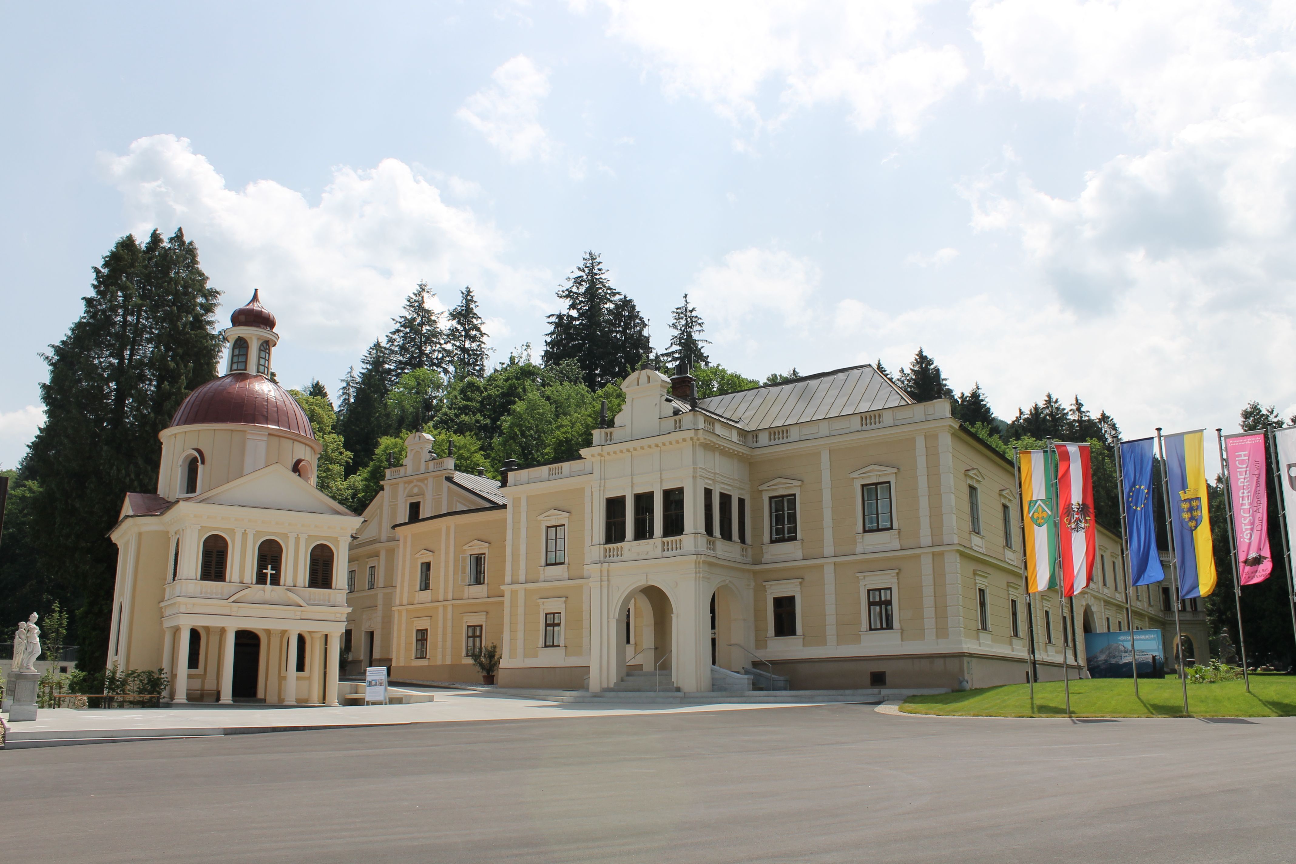 Neubruck Castle with chapel and flags in the foreground.