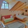 Room with sloping ceiling, double bed and sofa bed