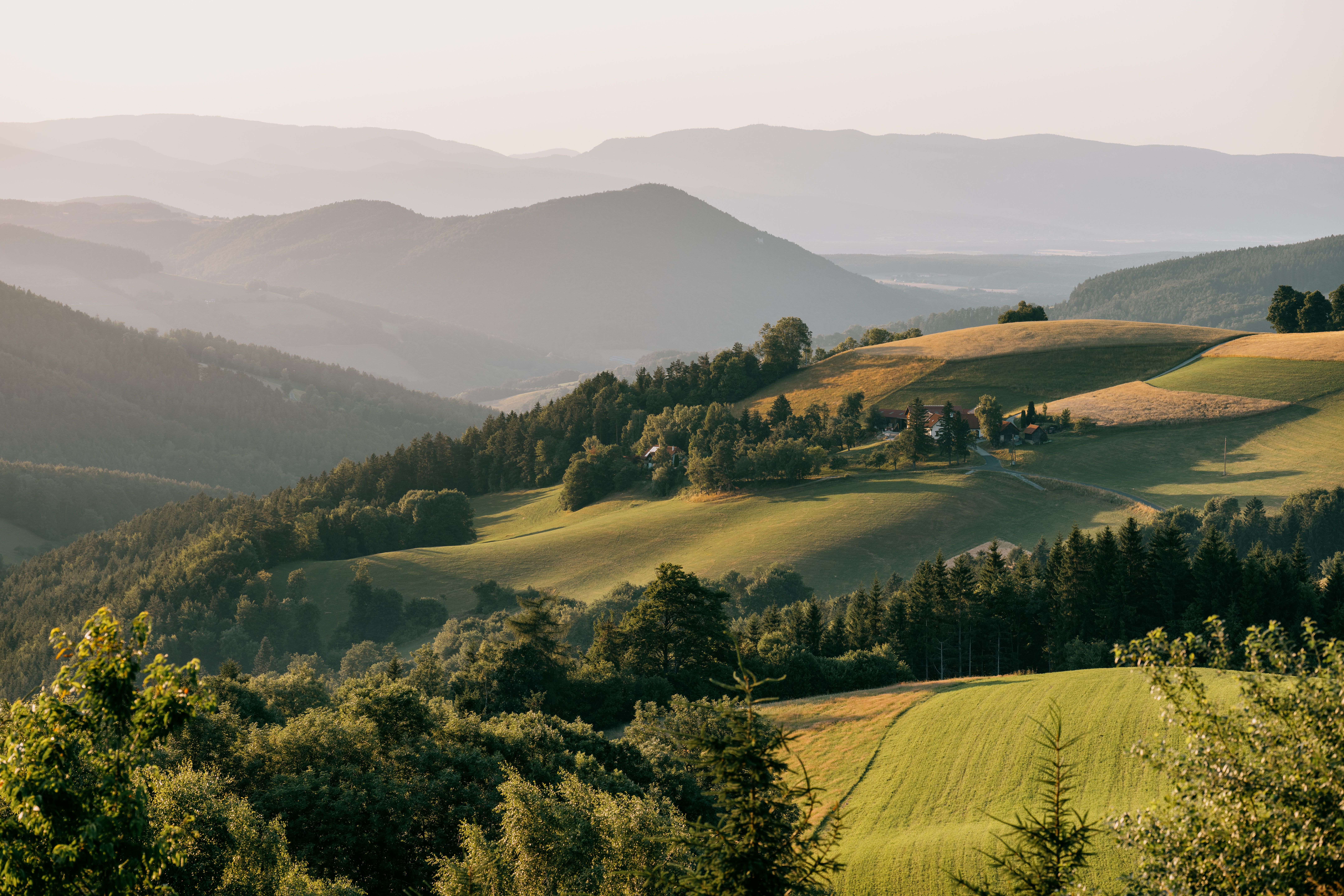 Landscape view along the viewing route with hills and forests at sunset.