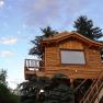 Wooden tree house with small balcony