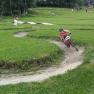 Child riding on a mini-bike parkour in the countryside.