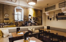 Cozy restaurant with a rustic mural of an old kitchen.