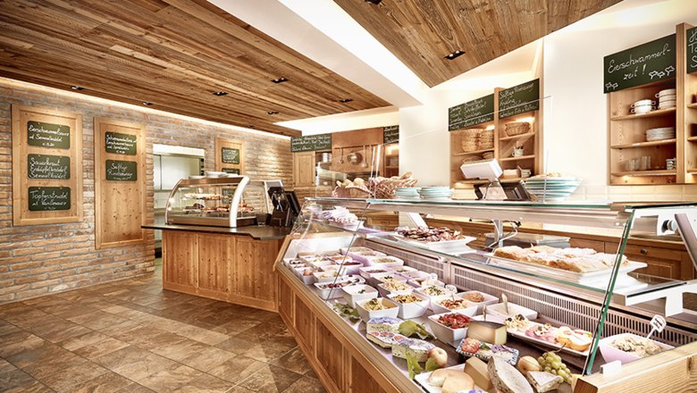 Interior view of a wine tavern with bar and food.