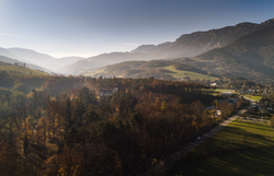 Die sanften Hügel und majestätischen Berge der Wiener Alpen umarmen das Schloss Wartholz, während die warmen Sonnenstrahlen die herbstlichen Farben der Wälder erleuchten. Ein malerischer Anblick, der die Seele beruhigt und zum Verweilen einlädt.