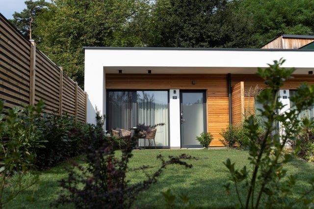 Modern guest house with wood paneling and garden.