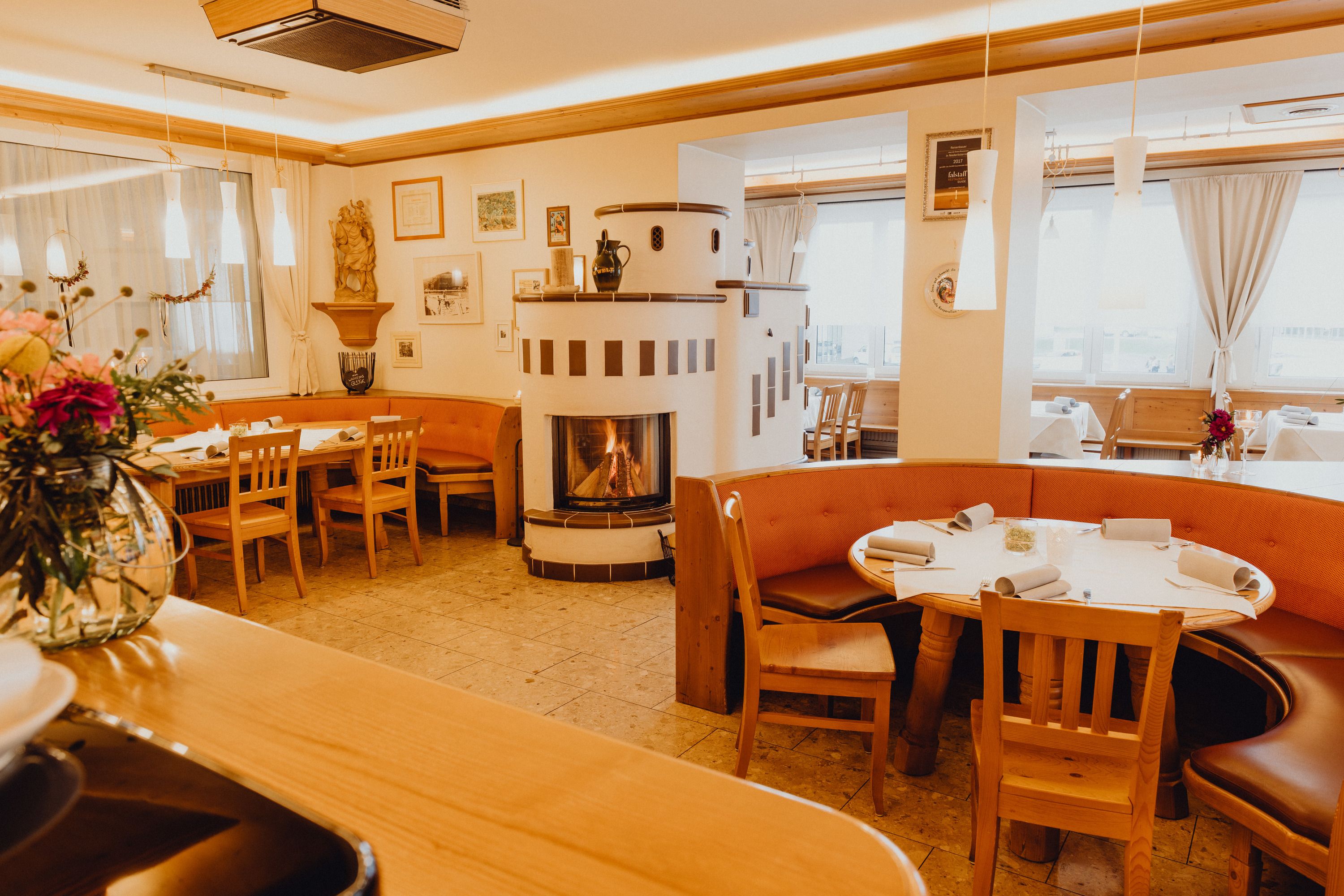 Cozy restaurant with fireplace and wooden furniture in the Vienna Alps.