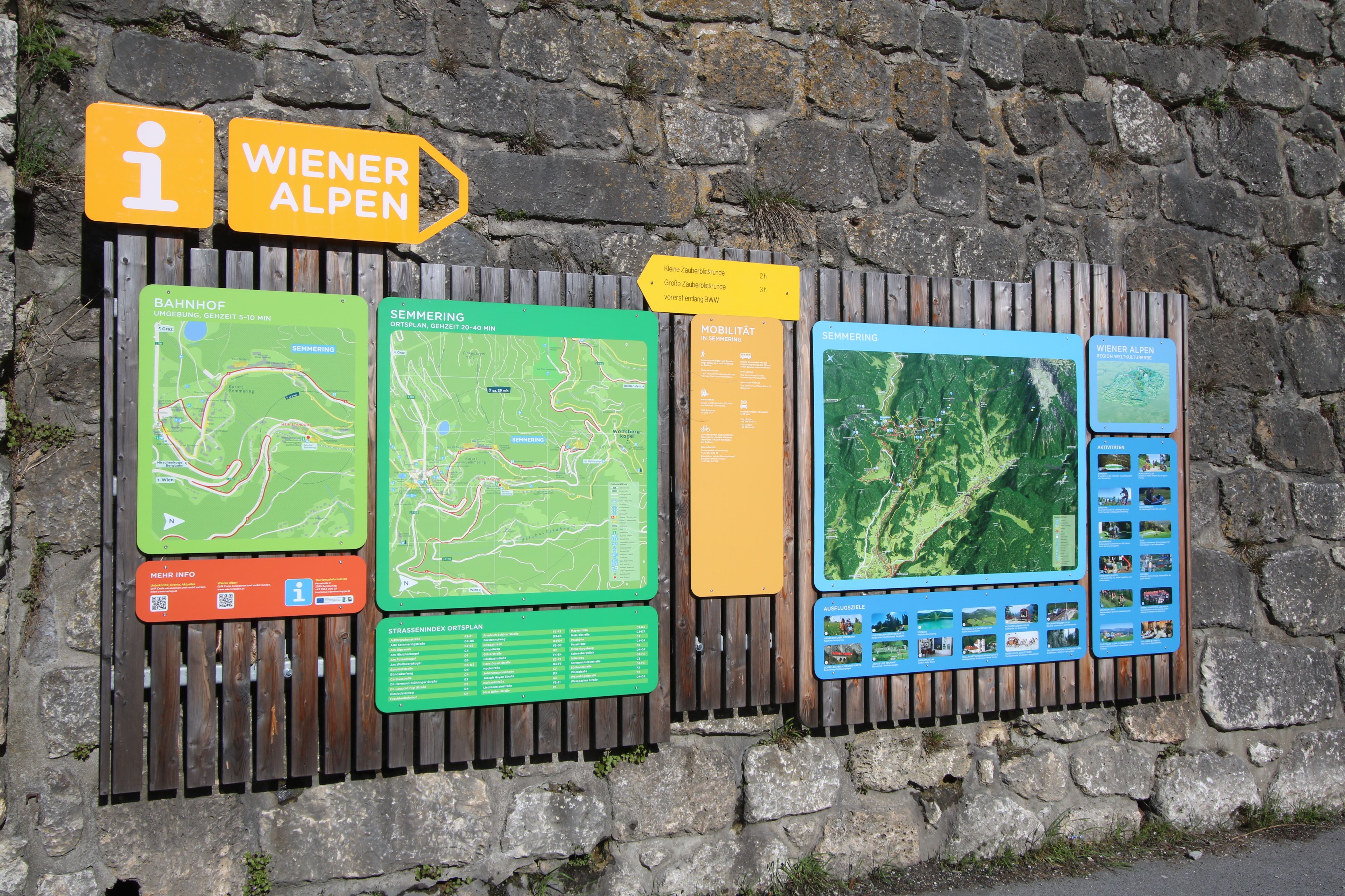 Information board at Semmering station with hiking maps and route descriptions in the Vienna Alps.