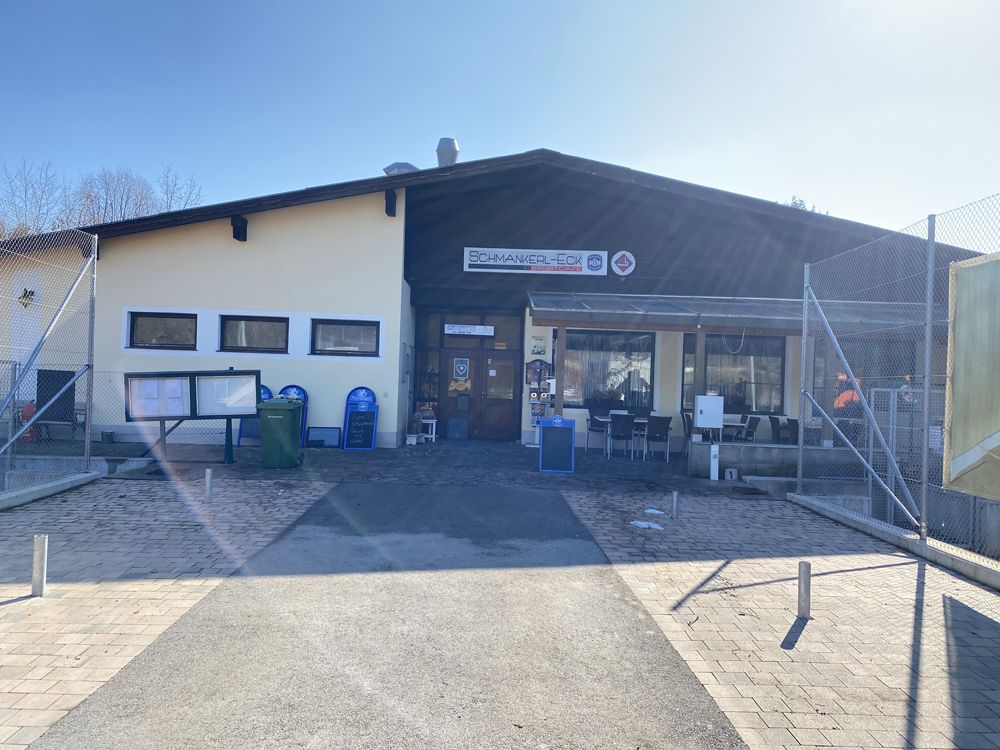 Exterior view of a building with the sign 'Schmankerl-Eck'.