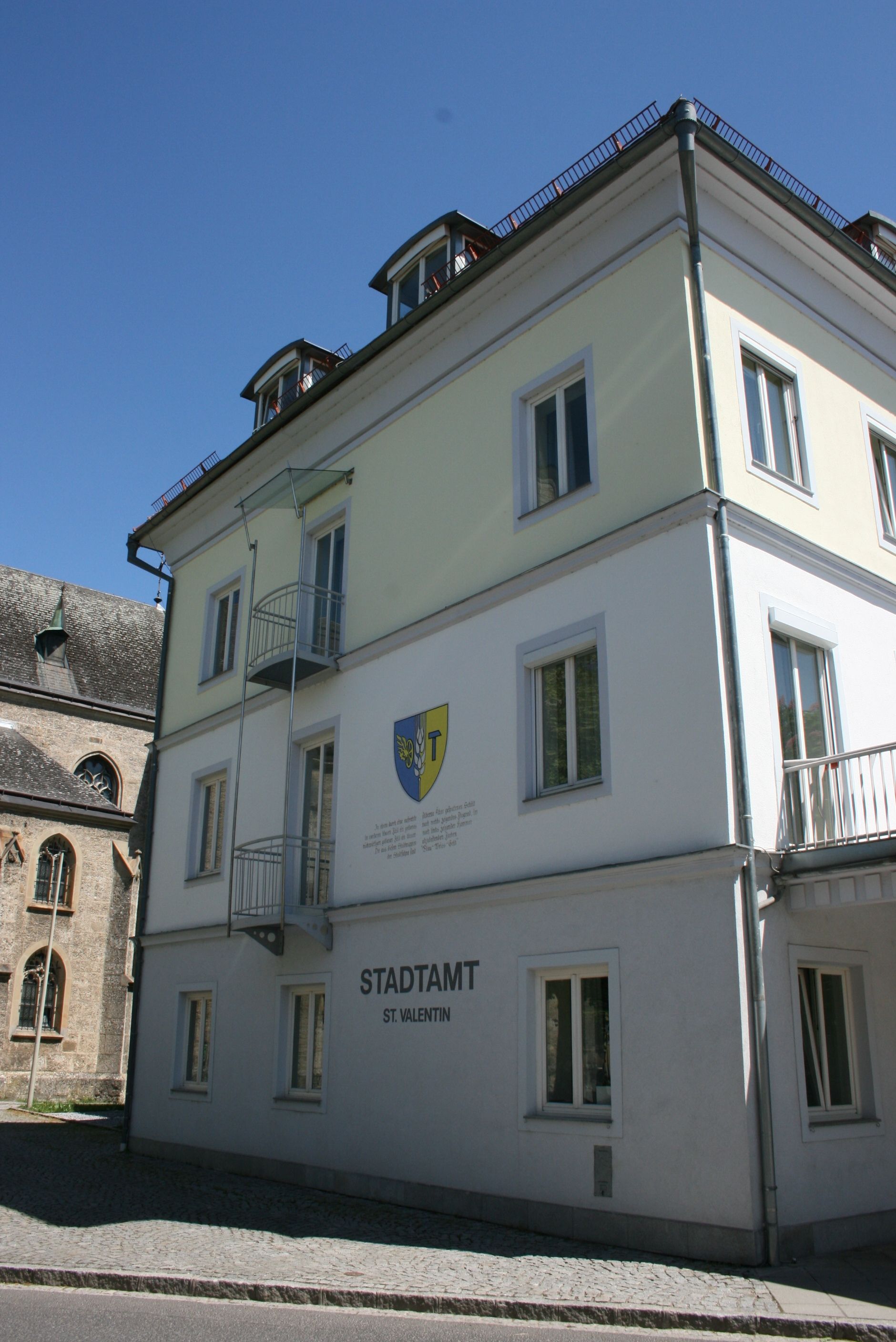 St. Valentin municipal office building with coat of arms on the façade.