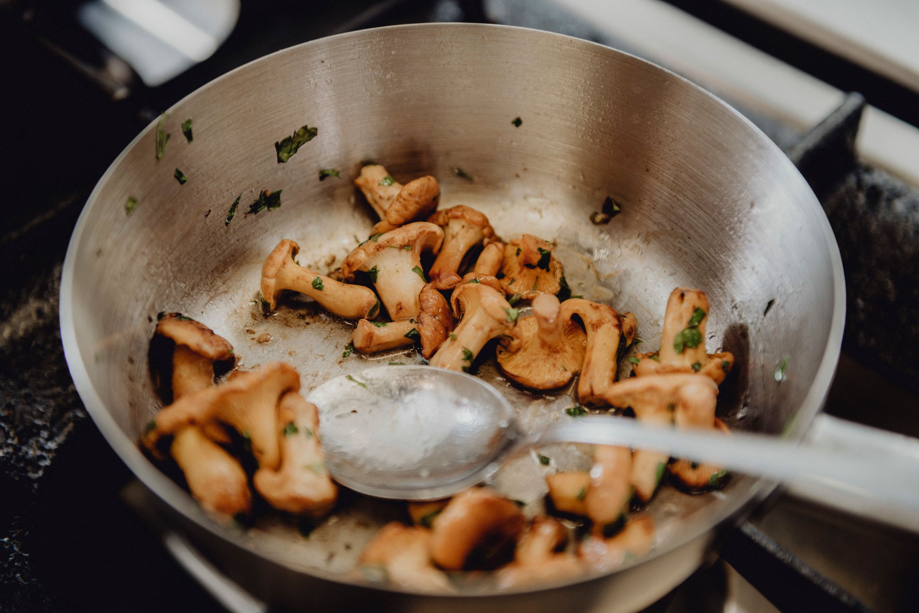 Chanterelles in a pan with herbs.