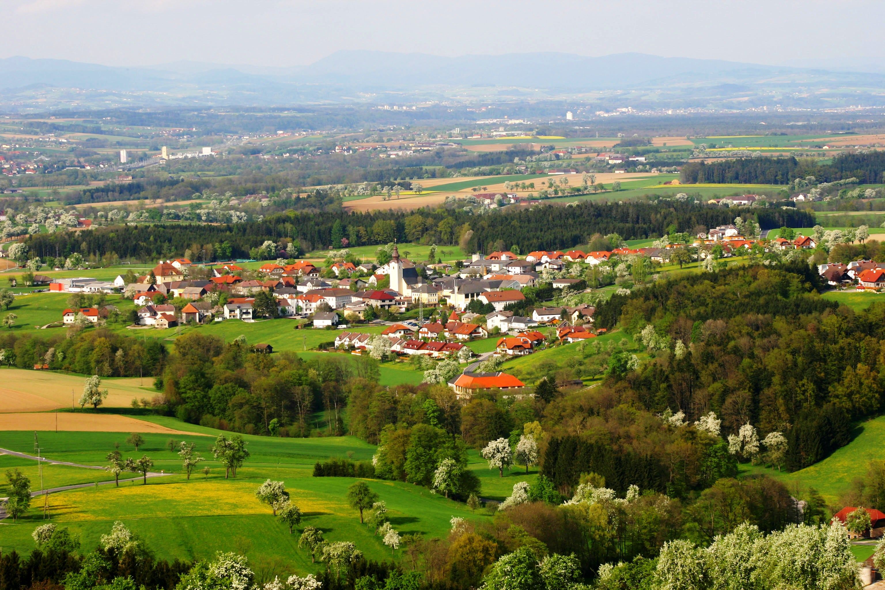 Aerial view of the municipality of Biberbach with green fields and forests.