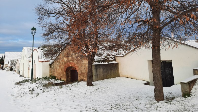 Snow-covered wine cellar lane in winter
