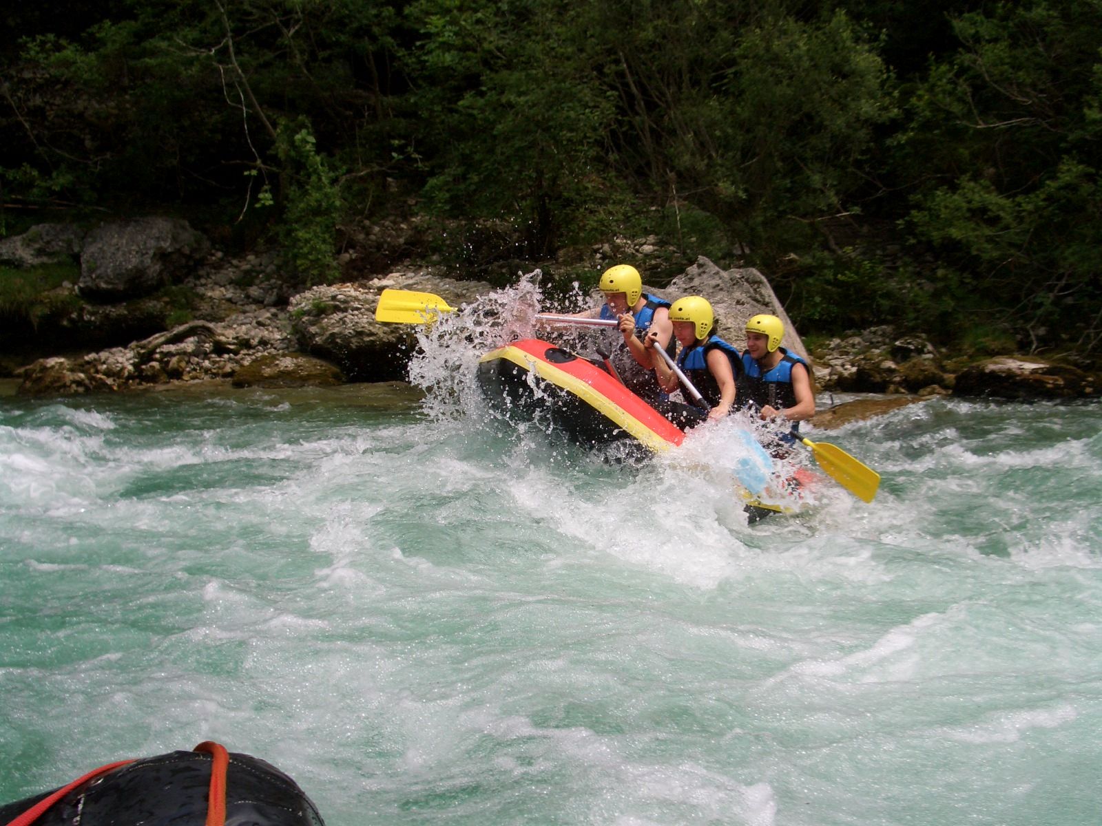 Group of people rafting on a wild river.